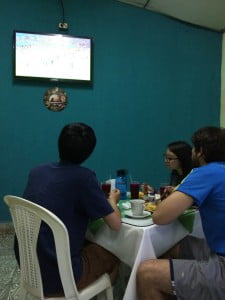 Sean, Crystal, and Bryan watch a futbol match on TV during our last dinner at Buffet Estelí.