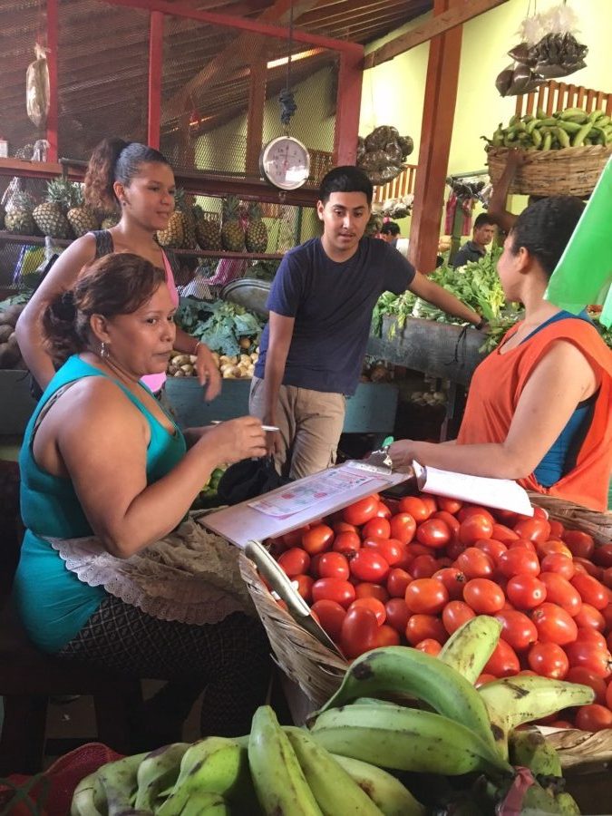 Jesus and Bianca at the vegetable stand with Martha the vendor!