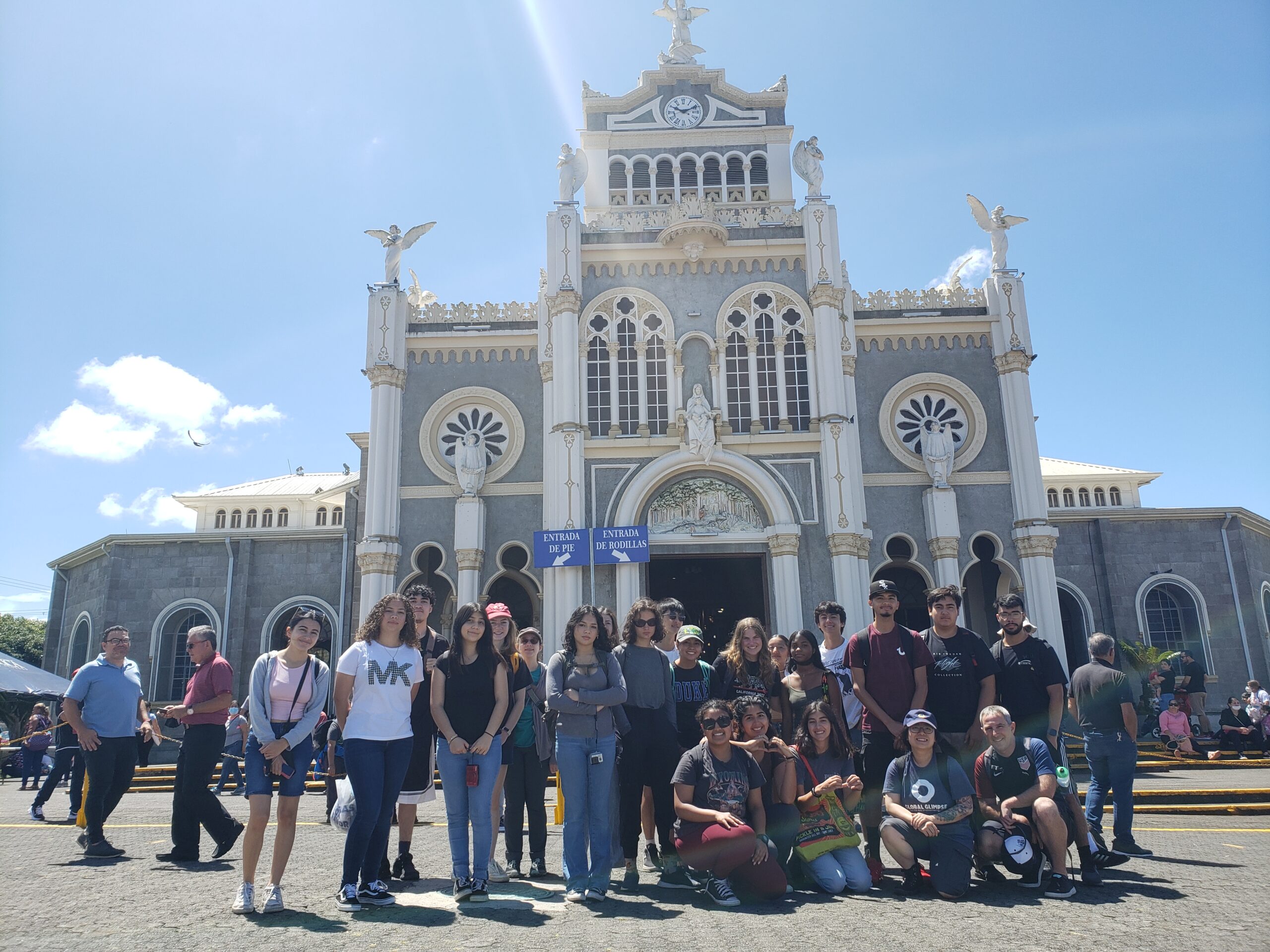 An incredibly brilliant group of people in front of a Basilica
